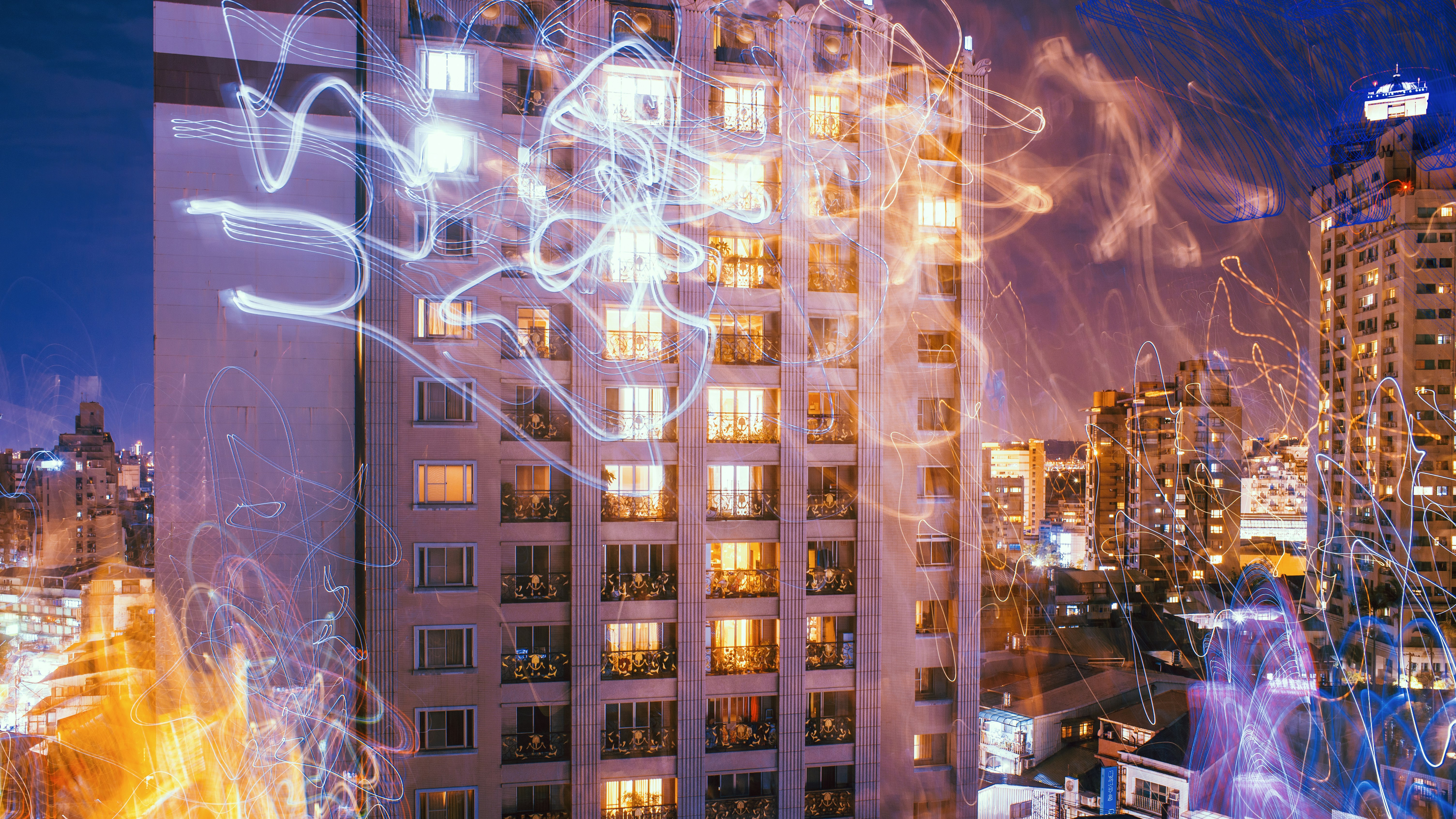 brown concrete building with lights turned on during night time